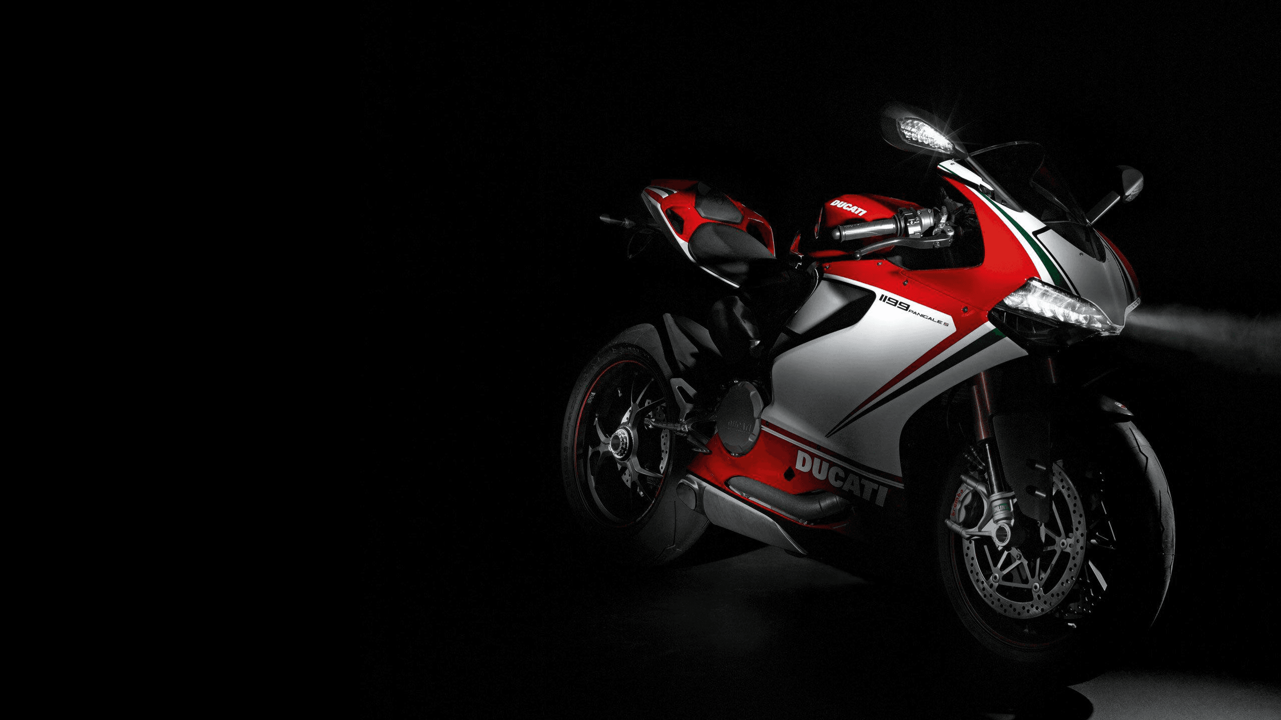 A Ducati 1199 Panigale lit against black